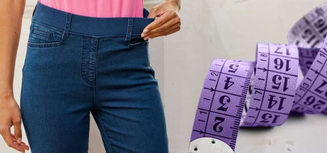 Nahaufnahme von einer Frau in einer Hose mit Maßband daneben.