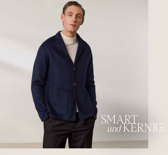 Mann in dunkelblauem Cardigan und hellen Rollkragenpullover, steht gegen neutralen Hintergrund. Text: "SMART und KERNIG".