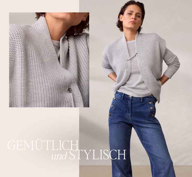 Frau in grauem Strickpullover und blauer Jeans, die Arme in die Hüften gestützt, Text: "GEMÜTLICH und STYLISCH".